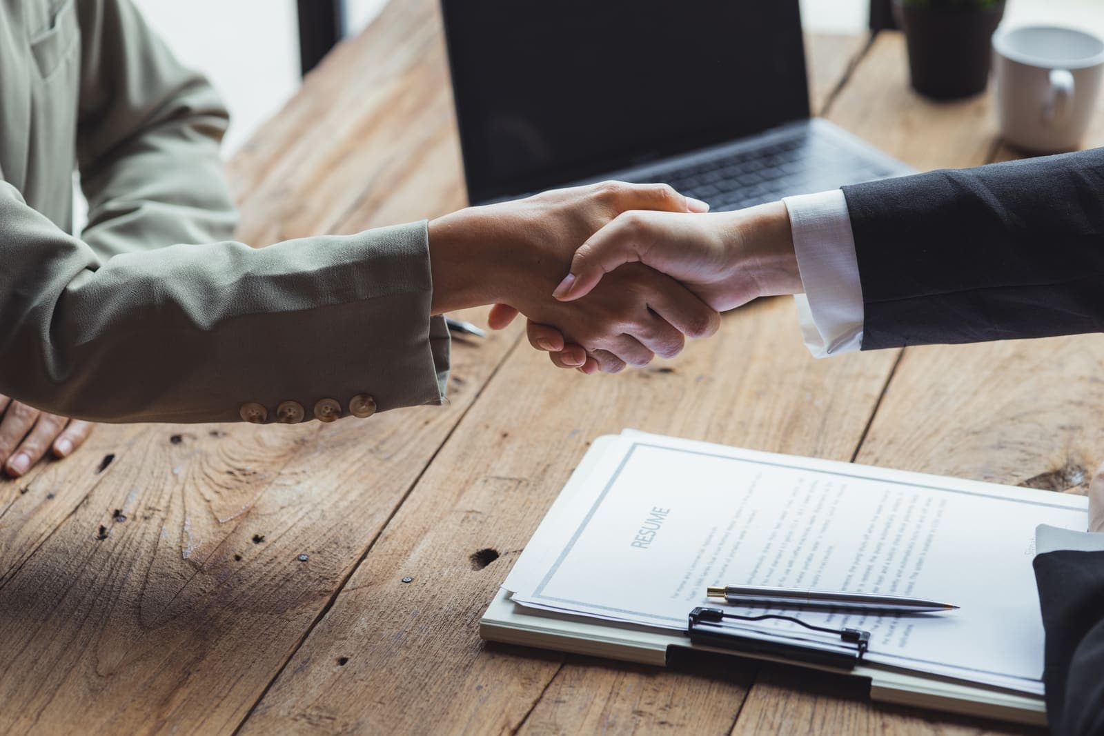Two business owners reviewing the terms of an acquisition