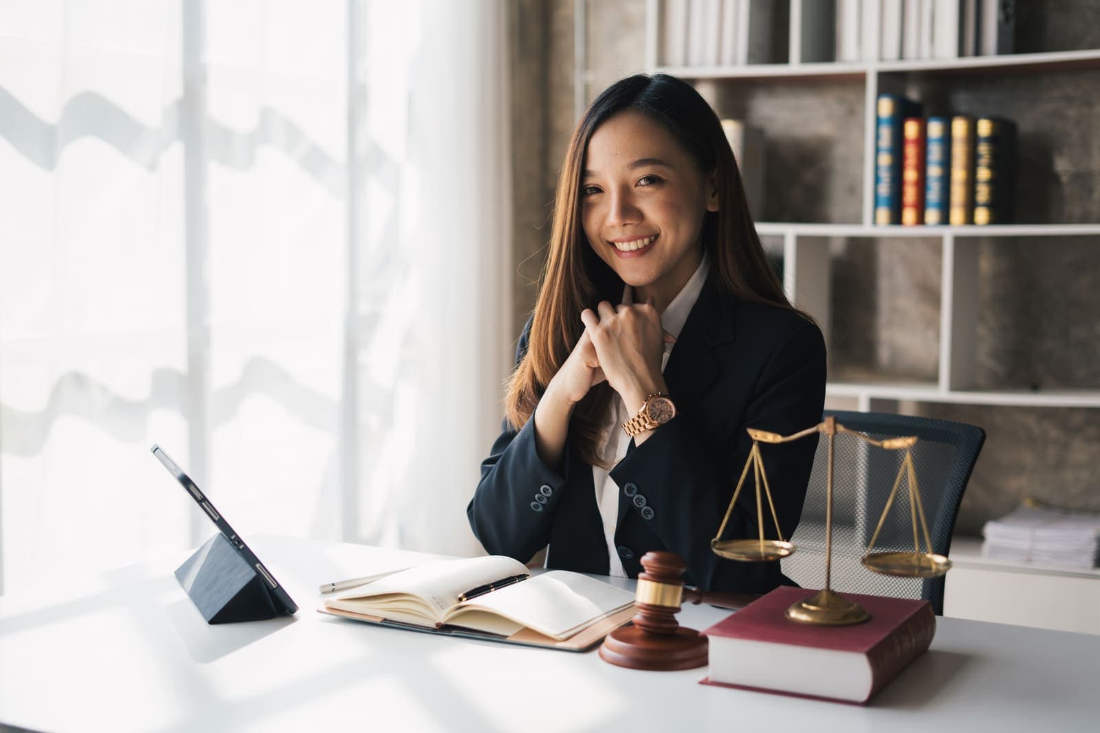 An attorney at a clean desk in daylight, boutique by design