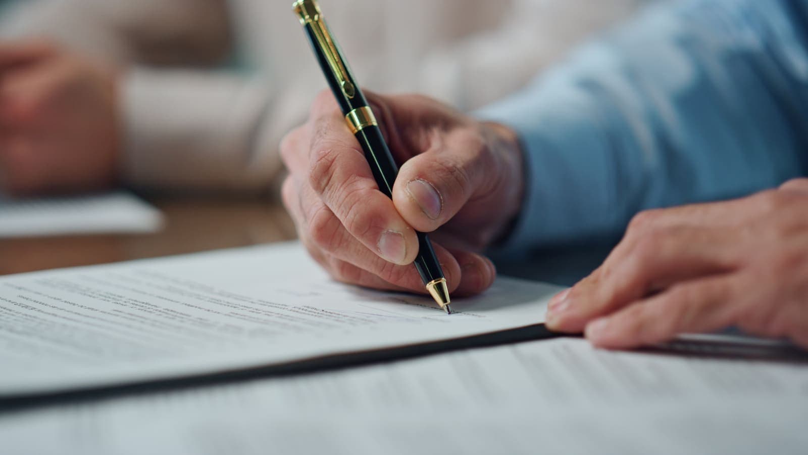 Signing the documents that close a business sale