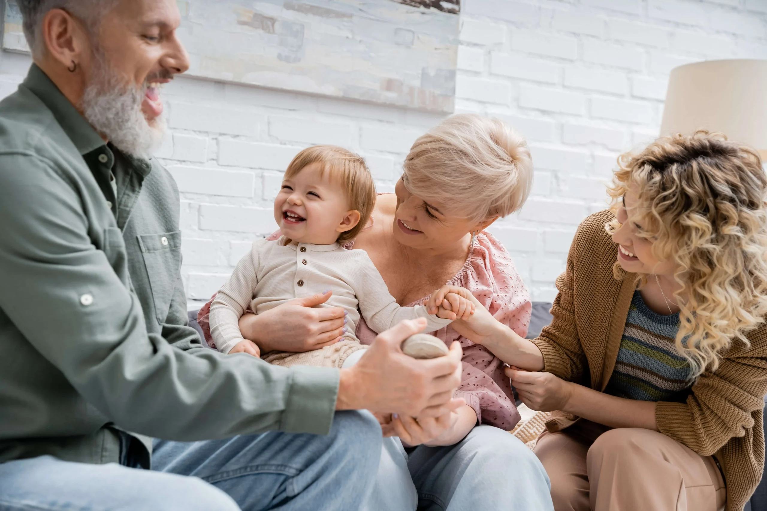 A multi-generational family, including grandparents, parents, and a child, sharing a joyful moment together, representing the peace of mind provided by customized estate plans and do-it-yourself wills.